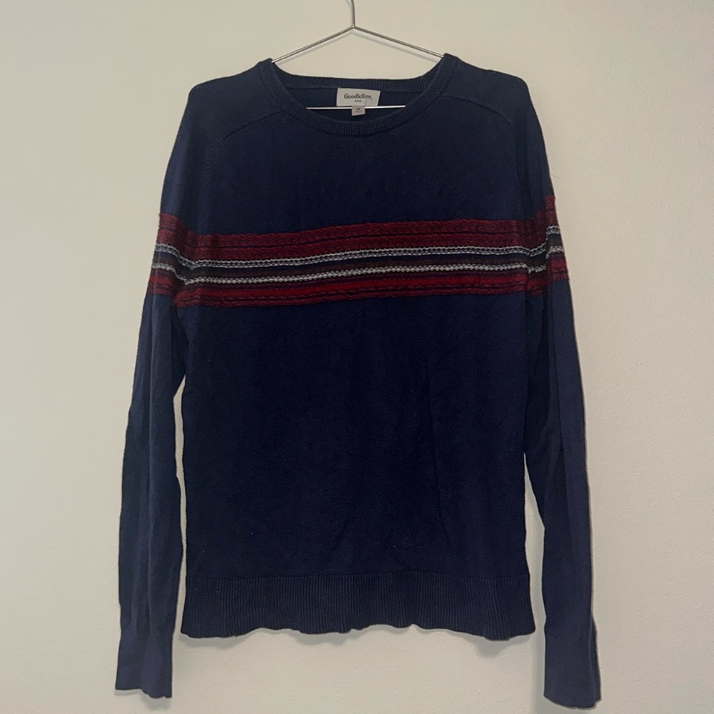 Knit sweater. Navy blue in color with red stripe detail.